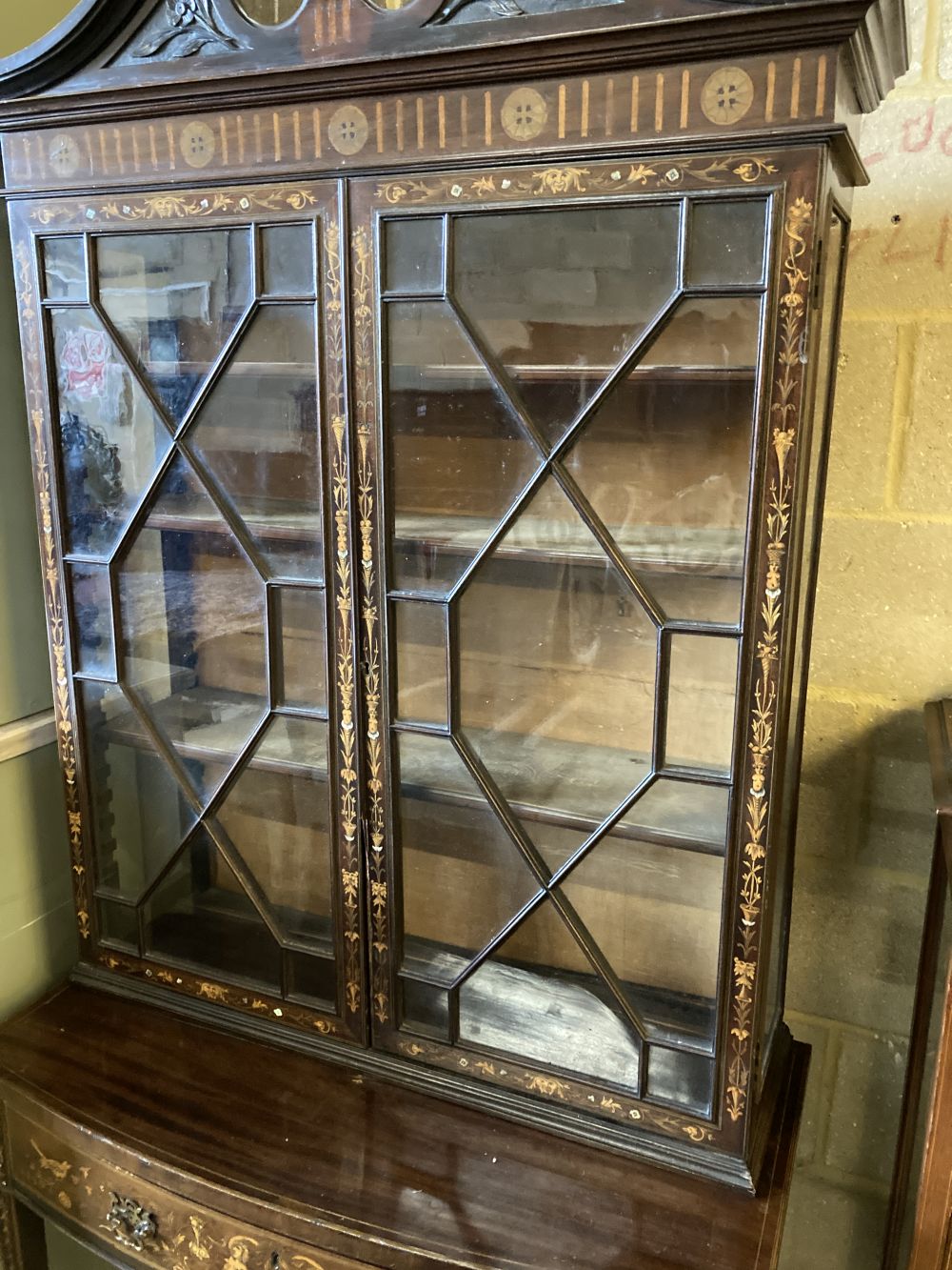 An Edwardian marquetry inlaid mahogany bow front display cabinet, width 92cm, depth 47cm, height 196cm